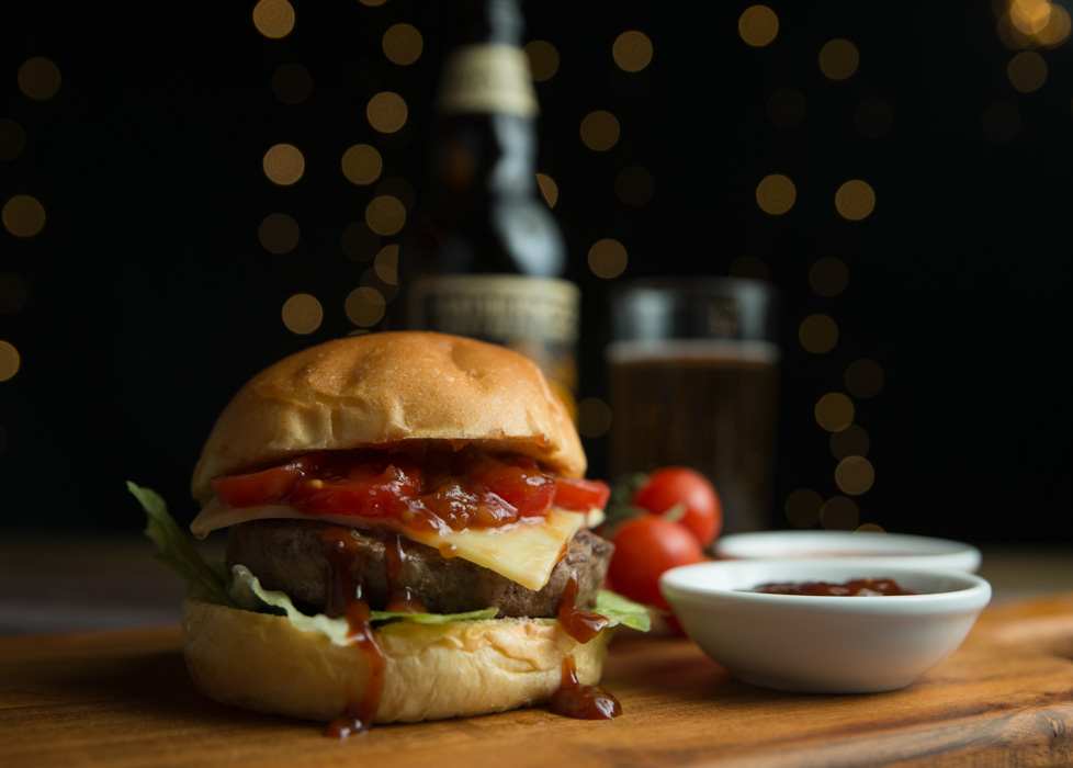 Food photography: Cheeseburger with relish and vine tomatoes